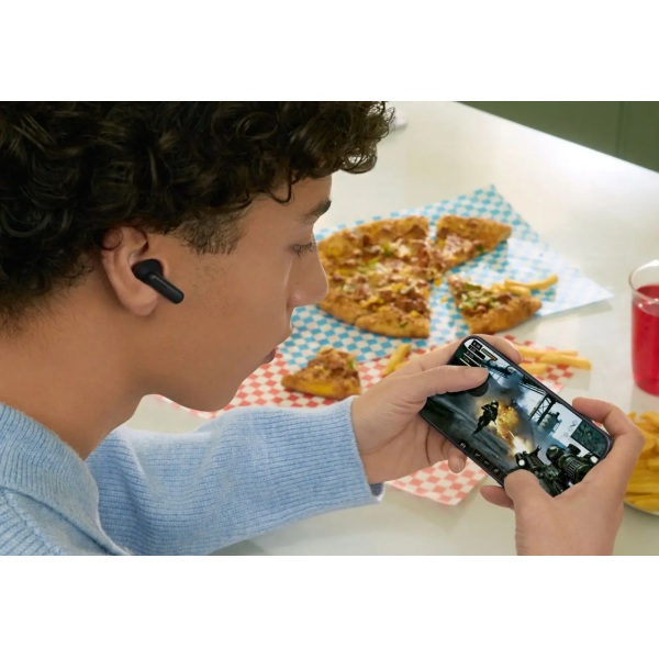 person playing a game on their phone with their earbuds in